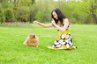 Girl playing with a dog in the park