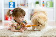 Cute little girl and funny dog at home